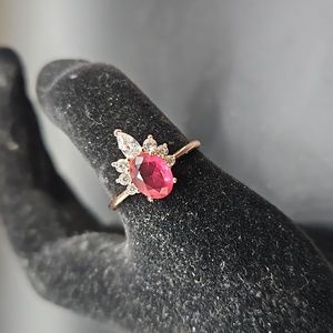 I-2 Rosegold tone ring with red stone and clear accents